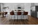 Modern kitchen featuring granite countertops, stainless steel appliances, an island, and hardwood flooring at 2709 Montie Ct, Lithia Springs, GA 30122