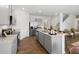 Contemporary kitchen featuring a breakfast bar, hardwood floors, stainless steel appliances, and granite countertops at 2709 Montie Ct, Lithia Springs, GA 30122