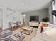 Open-concept living room featuring a comfortable white sofa and stylish decor and green accent wall at 2709 Montie Ct, Lithia Springs, GA 30122