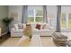 Inviting living room boasts a plush white sofa, chic decor, and scenic outdoor views at 2709 Montie Ct, Lithia Springs, GA 30122