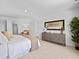 Bright bedroom features a neutral color palette, decorative dresser and comfortable furnishings at 2709 Montie Ct, Lithia Springs, GA 30122