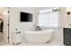 Bright bathroom with a freestanding tub, modern fixtures, and marble flooring at 2870 Redding Ne Rd, Atlanta, GA 30319