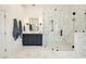 Modern bathroom showcasing a glass-enclosed shower, marble tile, and a stylish vanity with dual sinks at 2870 Redding Ne Rd, Atlanta, GA 30319