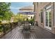 Outdoor dining on a wooden deck with an umbrella, set amongst lush greenery and brick accents at 2870 Redding Ne Rd, Atlanta, GA 30319