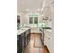 Well-lit kitchen with stainless steel appliances, white cabinets, and a stylish center island at 2870 Redding Ne Rd, Atlanta, GA 30319