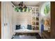Charming mudroom featuring a built-in bench, storage, and a unique round window with natural light at 2870 Redding Ne Rd, Atlanta, GA 30319