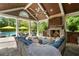 Charming outdoor area with a stone fireplace, ample seating, and a view of the sparkling pool, creating a relaxing space at 2870 Redding Ne Rd, Atlanta, GA 30319