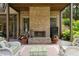Inviting outdoor fireplace on a covered patio with comfortable seating and brick surround at 2870 Redding Ne Rd, Atlanta, GA 30319