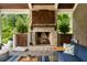 Close-up of the outdoor stone fireplace with wooden mantel, flanked by custom cabinets, creating a cozy ambiance at 2870 Redding Ne Rd, Atlanta, GA 30319