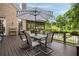 Outdoor patio featuring a dining table, a grill and views of the private backyard and greenery at 2870 Redding Ne Rd, Atlanta, GA 30319