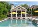 Inviting pool area with a covered outdoor living space, lounge chairs, and well-manicured landscaping at 2870 Redding Ne Rd, Atlanta, GA 30319