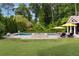 Beautiful backyard showcasing a luxurious pool, hot tub, lounge chairs, and lush landscaping at 2870 Redding Ne Rd, Atlanta, GA 30319