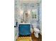 Charming powder room featuring patterned wallpaper, blue vanity, and stylish fixtures at 2870 Redding Ne Rd, Atlanta, GA 30319