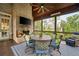 Charming screened porch with brick fireplace, TV, comfortable seating, and picturesque views at 2870 Redding Ne Rd, Atlanta, GA 30319