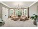 Comfortable sitting area with plush chairs, ottomans, a chandelier, and natural lighting at 2870 Redding Ne Rd, Atlanta, GA 30319
