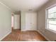 This bedroom features hardwood floors, double door closet, and a large window for natural light at 4201 Hicks Rd, Austell, GA 30106