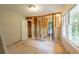 A gutted bedroom shows the potential for renovation with a window and doorway at 4201 Hicks Rd, Austell, GA 30106