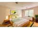 Stylishly decorated bedroom with a wooden bed frame, colorful pillows and natural light at 4201 Hicks Rd, Austell, GA 30106
