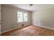 Bedroom with hardwood floors and window overlooking trees at 4201 Hicks Rd, Austell, GA 30106