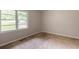 An empty bedroom has a double window and is ready for renovation with new flooring at 4201 Hicks Rd, Austell, GA 30106