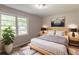 Cozy bedroom with neutral tones, two bedside tables, and a large window offering natural light at 4201 Hicks Rd, Austell, GA 30106