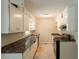 Galley kitchen featuring dark countertops, white cabinetry, and modern appliances at 4201 Hicks Rd, Austell, GA 30106