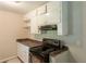Kitchen featuring white cabinets, dark countertops, and black appliances at 4201 Hicks Rd, Austell, GA 30106