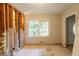 A gutted room shows the potential for renovation with a window and doorway at 4201 Hicks Rd, Austell, GA 30106