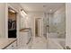Large bathroom featuring a glass shower, soaking tub, double vanity, and a walk-in closet for ample storage at 13055 Fox Rd, Alpharetta, GA 30005
