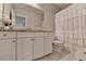 Charming bathroom with granite countertops, white cabinetry, and shower at 13055 Fox Rd, Alpharetta, GA 30005