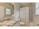 Bright bathroom with a granite countertop vanity, tub, shower and lots of light at 13055 Fox Rd, Alpharetta, GA 30005