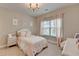 Charming bedroom with soft pink accents, a decorative chandelier, and lots of natural light at 13055 Fox Rd, Alpharetta, GA 30005