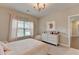 Inviting bedroom featuring neutral tones, a window view, and a comfortable aesthetic at 13055 Fox Rd, Alpharetta, GA 30005