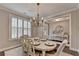 Charming dining room features a chandelier and plantation shutters at 13055 Fox Rd, Alpharetta, GA 30005