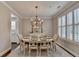 Elegant dining room with chandelier, plantation shutters, and neutral decor at 13055 Fox Rd, Alpharetta, GA 30005