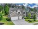 Charming two-story home with a three-car garage and manicured landscaping at 13055 Fox Rd, Alpharetta, GA 30005