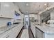 Modern kitchen with white cabinetry, stainless steel appliances, granite countertops, and stylish pendant lights at 13055 Fox Rd, Alpharetta, GA 30005