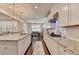 Bright white kitchen featuring granite countertops, stainless steel appliances, and decorative pendant lighting at 13055 Fox Rd, Alpharetta, GA 30005