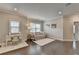 Comfortable living area with hardwood floors, a cozy sofa, a desk, and plenty of natural light from the windows at 13055 Fox Rd, Alpharetta, GA 30005