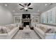 Cozy living room with a stone fireplace, built-in shelving, plantation shutters, and comfortable seating at 13055 Fox Rd, Alpharetta, GA 30005