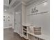 Entryway mudroom features a built-in storage bench, hooks, and access to the upper level at 13055 Fox Rd, Alpharetta, GA 30005