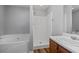 Bathroom showcasing a garden tub and shower with a wood-look vanity at 140 Moseley Dr, Stockbridge, GA 30281