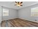Bright bedroom featuring wood-look flooring, a ceiling fan, and natural light at 140 Moseley Dr, Stockbridge, GA 30281