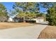 View of the home from the long driveway leading up to an attached two car garage at 140 Moseley Dr, Stockbridge, GA 30281