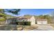 Charming home featuring a large driveway leading to both attached and detached two-car garages at 140 Moseley Dr, Stockbridge, GA 30281