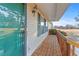 Inviting covered front porch with a teal front door and wood railing at 140 Moseley Dr, Stockbridge, GA 30281