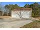 Detached garage with two bays and a wide concrete driveway at 140 Moseley Dr, Stockbridge, GA 30281