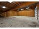 Large garage interior with wood framing, concrete floors, and bright lighting at 140 Moseley Dr, Stockbridge, GA 30281