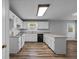 Spacious kitchen with white cabinets, modern appliances, and vinyl plank flooring at 140 Moseley Dr, Stockbridge, GA 30281