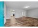 Open living room featuring wood look floors and a view into the kitchen at 140 Moseley Dr, Stockbridge, GA 30281